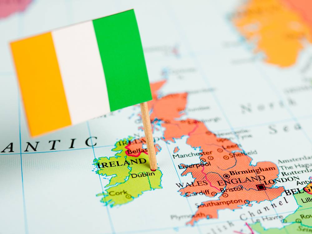 Close up of a map of the UK and Ireland with an Irish flag pinned to Dublin